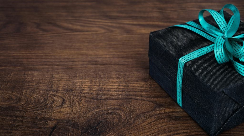 Elevating Monet Jewelry's Appeal: 6 Creative Packaging Ideas to Boost Sales - black gift box with blue ribbon 1024x570