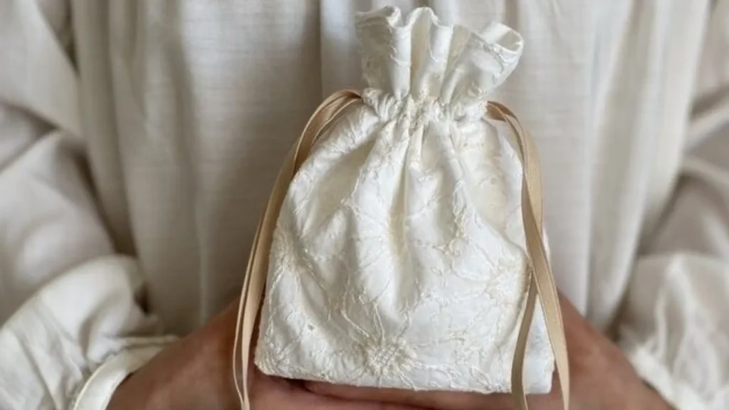 holding a cotton jewelry pouch
