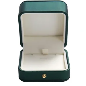 An open, square-shaped jewelry box with a dark green exterior, white plush interior, and a gold knob.