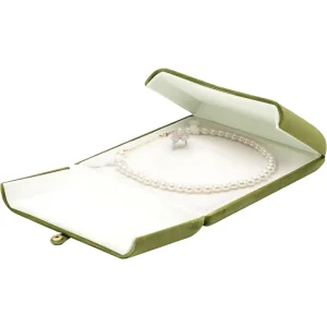 Green velvet jewelry case with a pearl necklace and ring displayed inside on a white background.