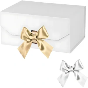 White gift box adorned with a golden satin bow, and a smaller silver satin bow beside it