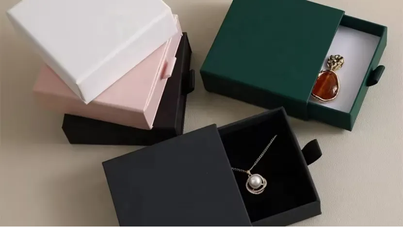 assorted jewelry boxes with earrings and perfume bottle