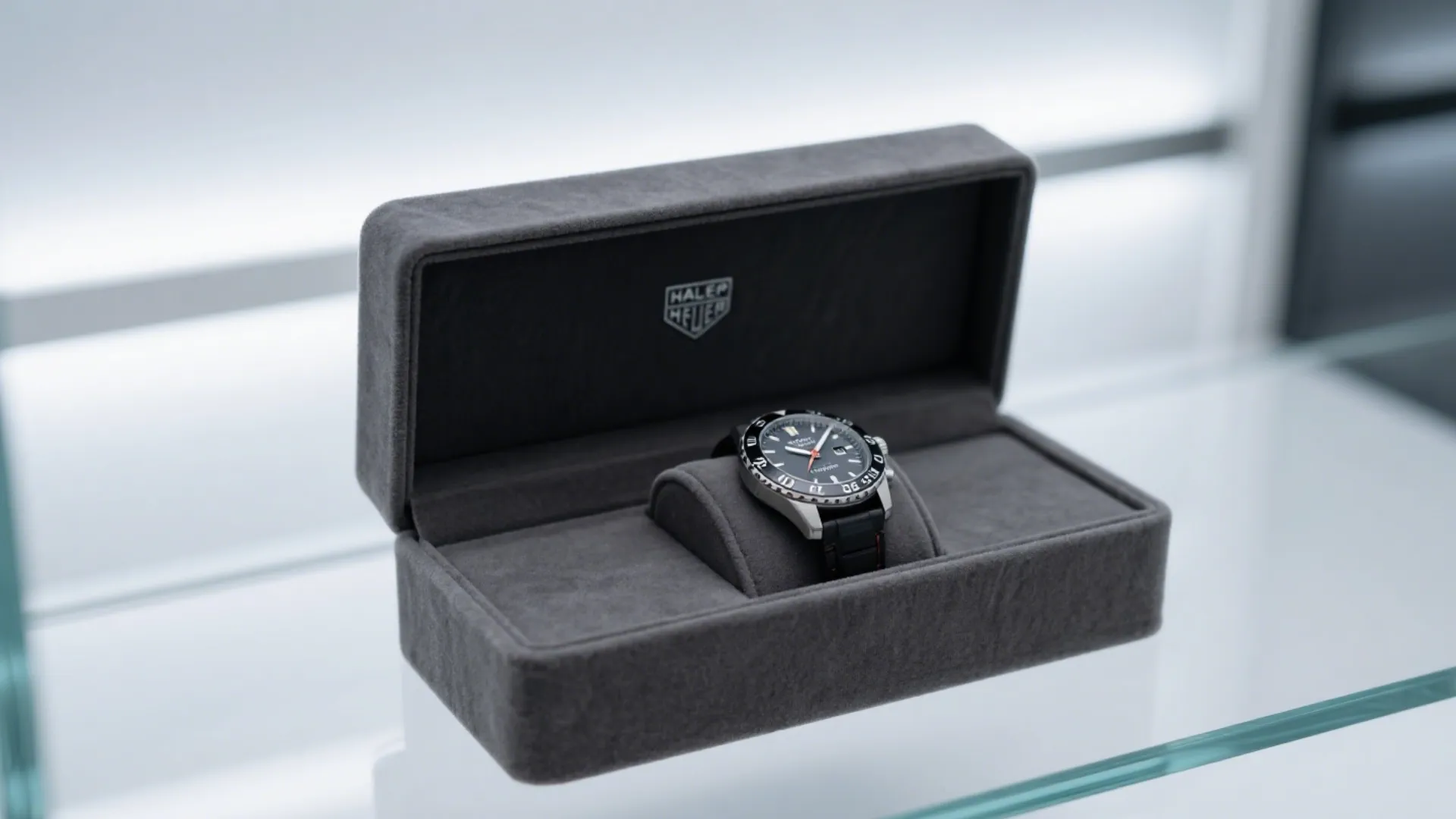 gray velvet watch box with luxury timepiece
