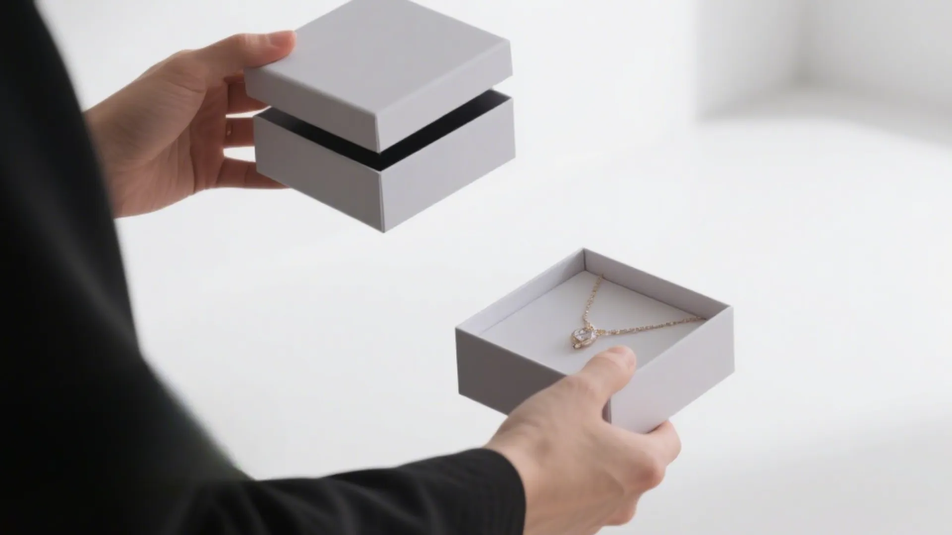 hands holding stackable jewelry boxes