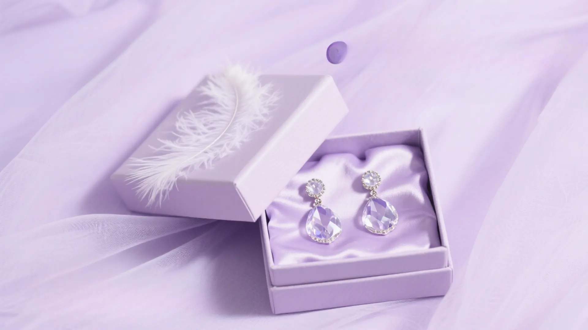 purple jewelry box with earrings on lilac fabric