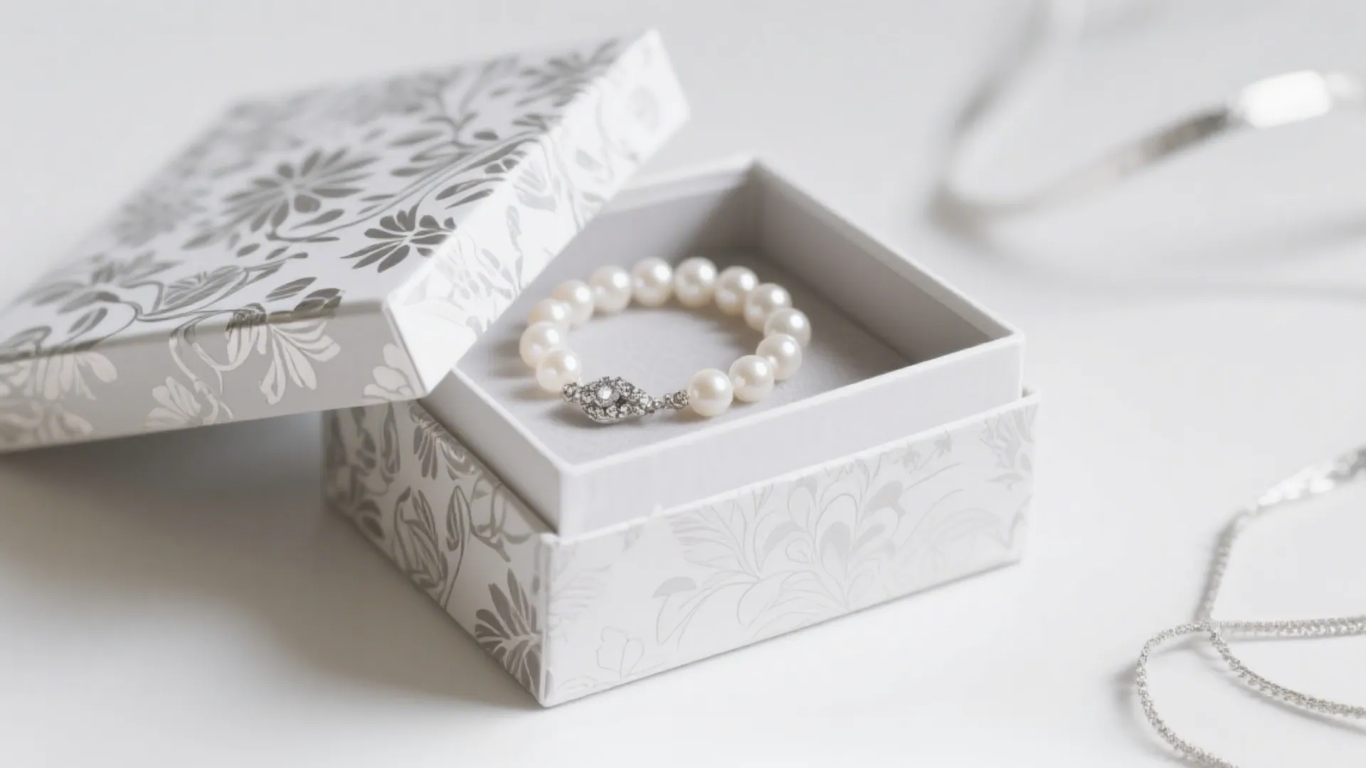 Two-piece lid and base jewelry box with pearl necklace