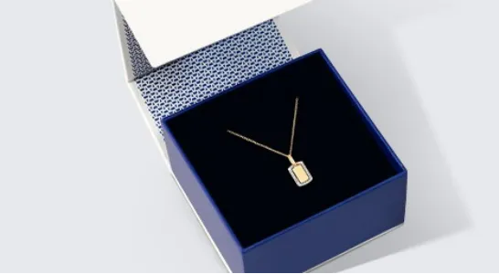 blue jewelry box with gold necklace