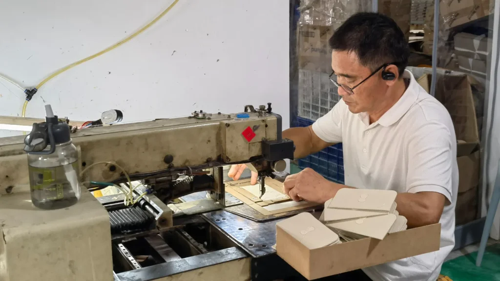 jewelry packaging manufacturing process worker sewing