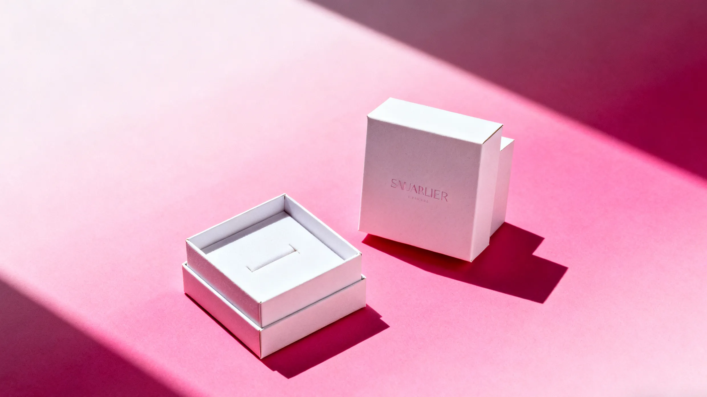 white jewelry boxes on pink