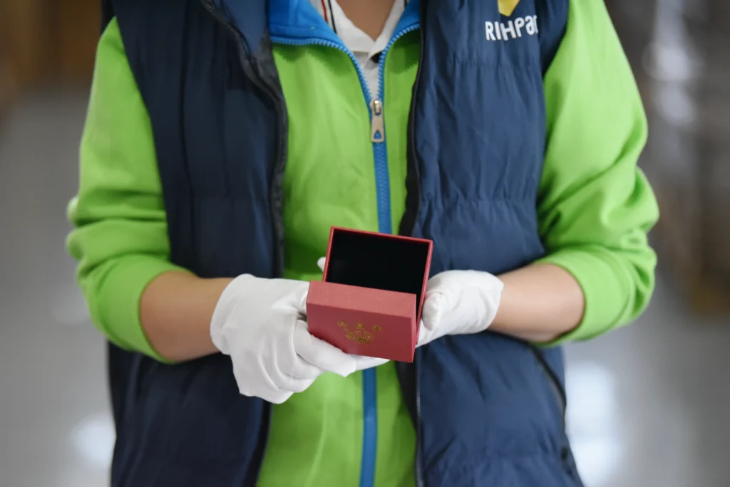 Richpack jewelry box factory worker performing final quality control on finished box