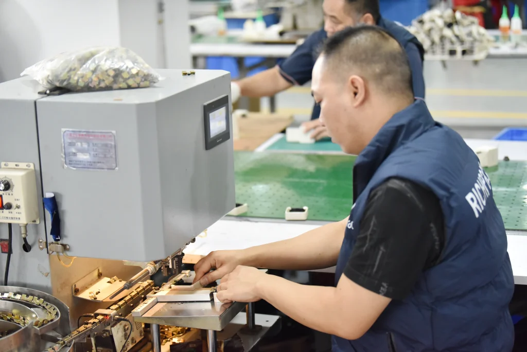 Richpack jewelry box factory worker installing hinges with automated machine