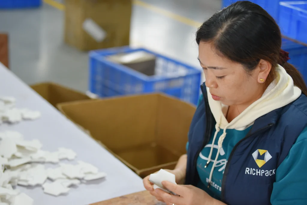 Richpack jewelry box artisan assembling custom inserts for box components in factory workshop