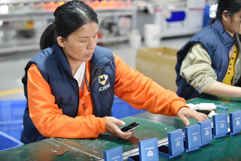 Richpack jewelry box artisan placing custom inserts into luxury jewelry boxes in factory workshop