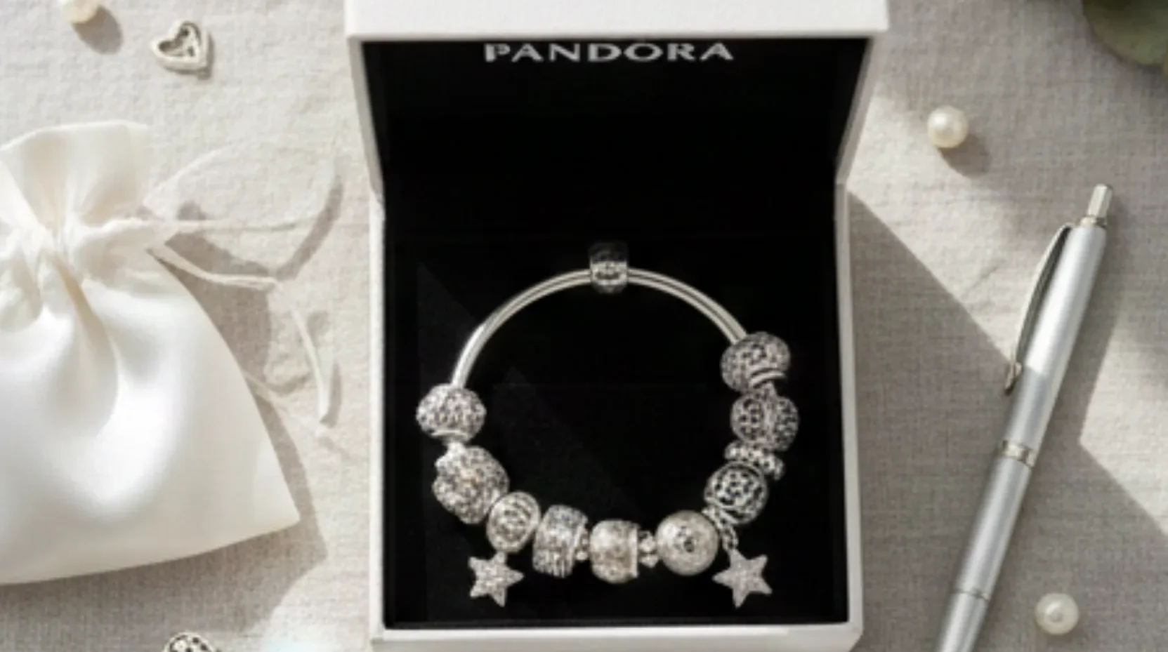 Pandora silver charm bracelet (with star & crystal beads) in branded gift box, styled with pearls & silk pouch