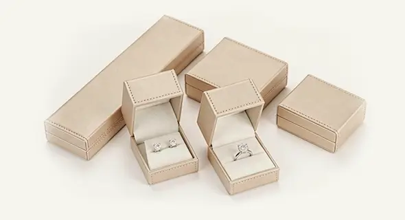 Luxury beige leatherette jewelry gift box set: long necklace box, square earring box, ring box & pendant box. Premium custom packaging for fine jewelry brands by Richpack.