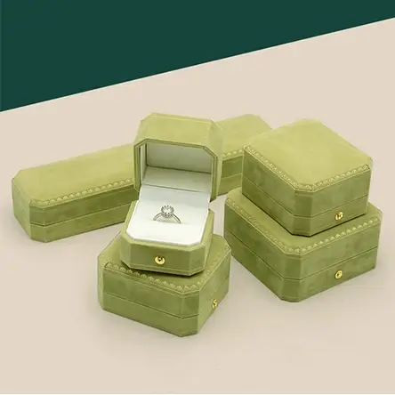 Light green velvet jewelry boxes with gold snap buttons, including ring box and necklace box, with soft white lining.