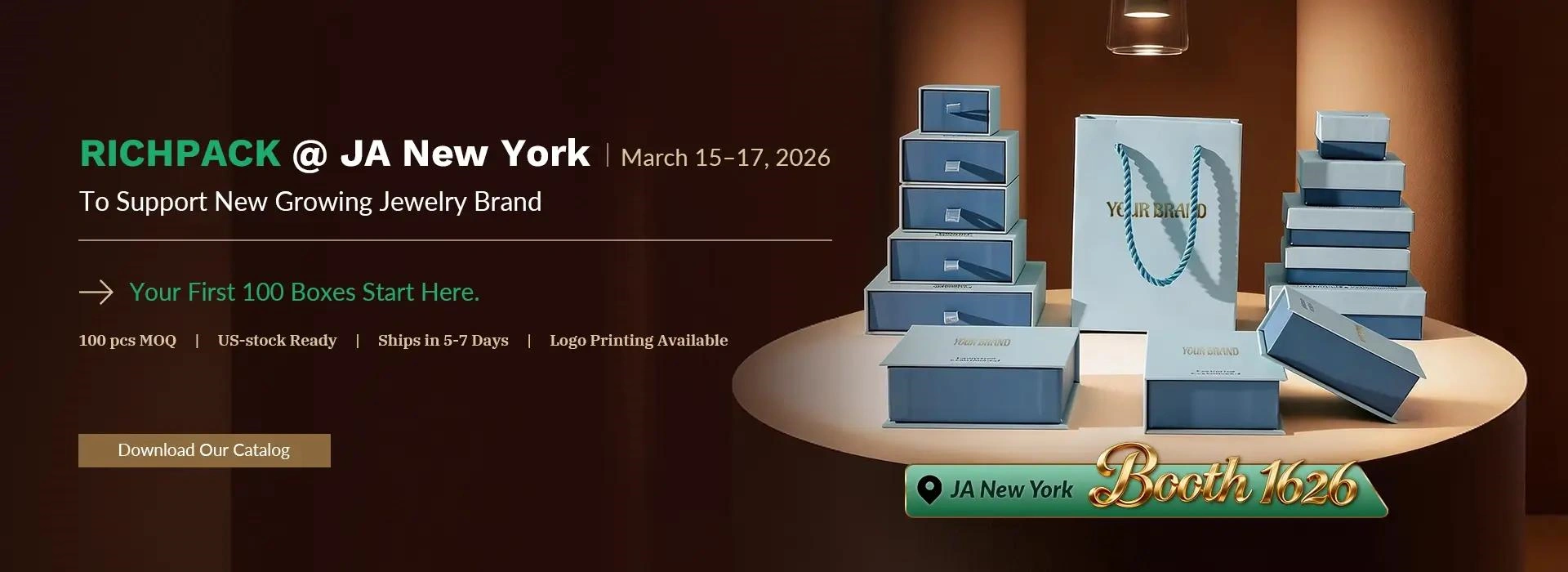 Richpack JA New York Spring Show 2026 promotional banner featuring stacked blue and white luxury jewelry boxes, a branded shopping bag, and key details: March 15-17, 2026 at Javits Center, Booth #1626, 100 pcs MOQ, US stock, 5-7 day shipping, and logo printing options.