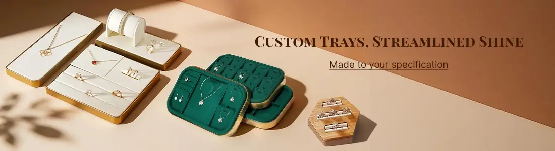 Custom jewelry trays in white velvet and green velvet, with gold trim and wooden accents, designed to showcase fine jewelry.