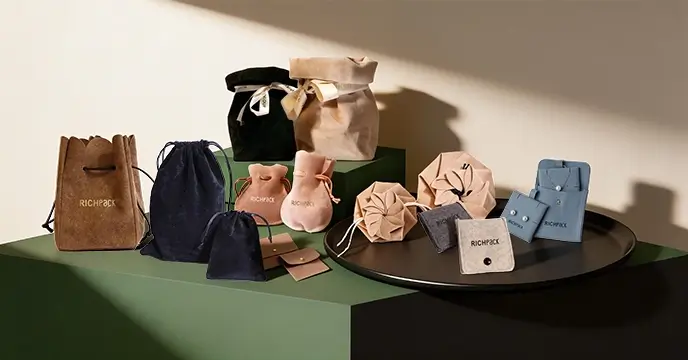 Assortment of custom velvet jewelry pouches in various colors, shapes, and styles with Richpack branding.